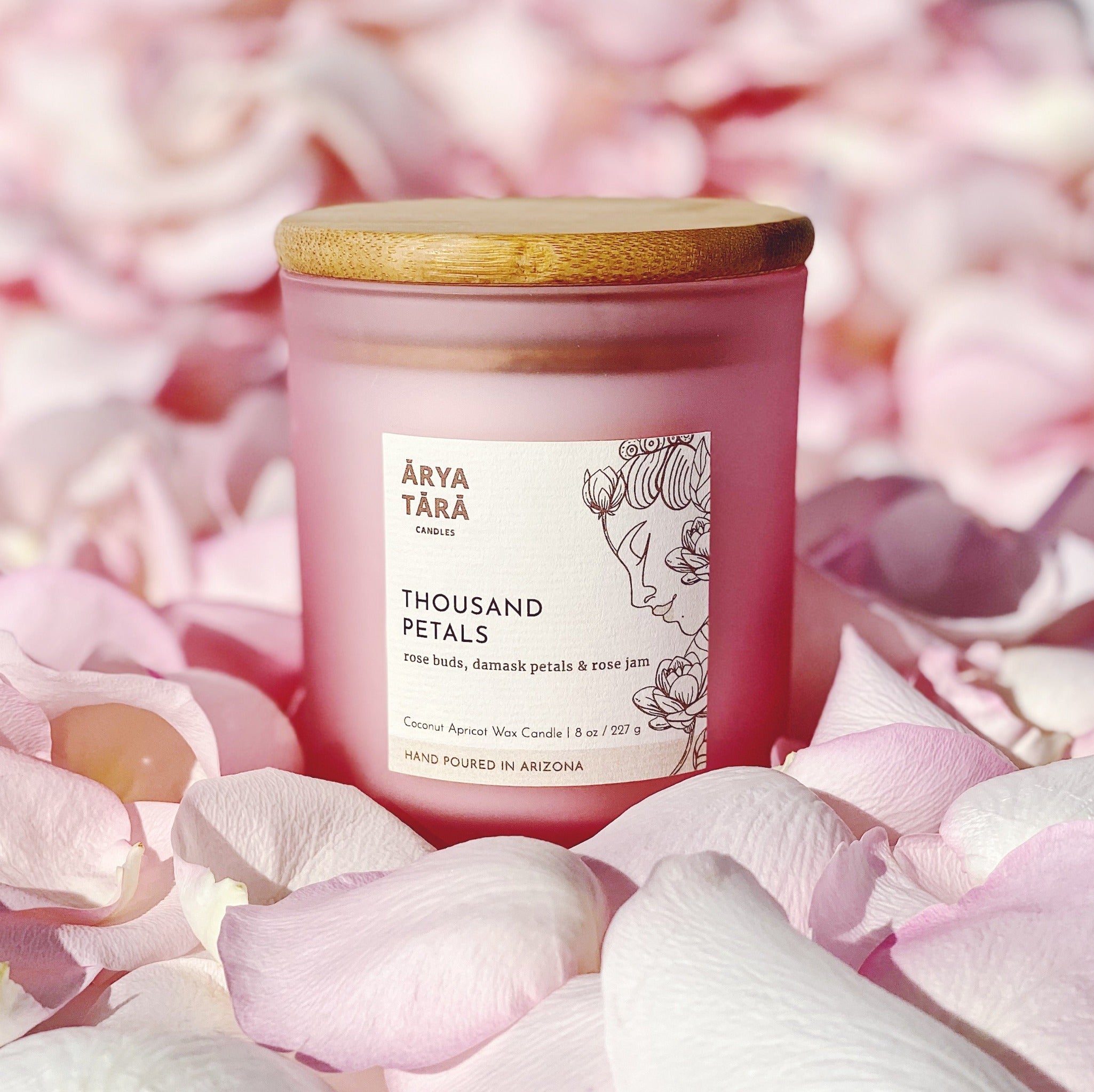 Thousand Petals Candle by Arya Tara Candles. Rose petal scent, floral fragrance. Rose buds, Damask rose petals, rose jam. Pink candle, pink candle jar. Rose oil candle, rose essential oil. Non-toxic natural candle made with coconut apricot wax, lead-free zinc-free wicks, premium fragrances. Luxury candle, natural candle. Made in Tucson Arizona, hand poured candle in small batch. Self care candle.